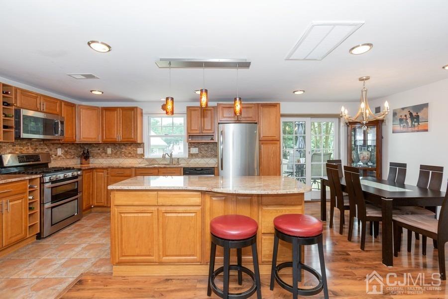 817 Dunellen Avenue Dunellen, NJ 08812 - Photo 9 of 20 a kitchen with stainless steel appliances granite countertop a stove and a sink