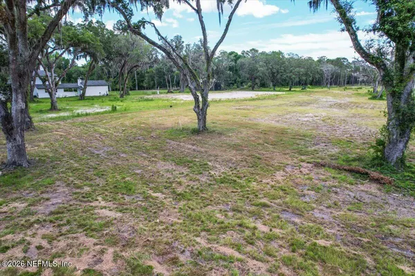 a view of outdoor space with trees all around