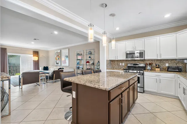 a kitchen with center island table and chairs in it