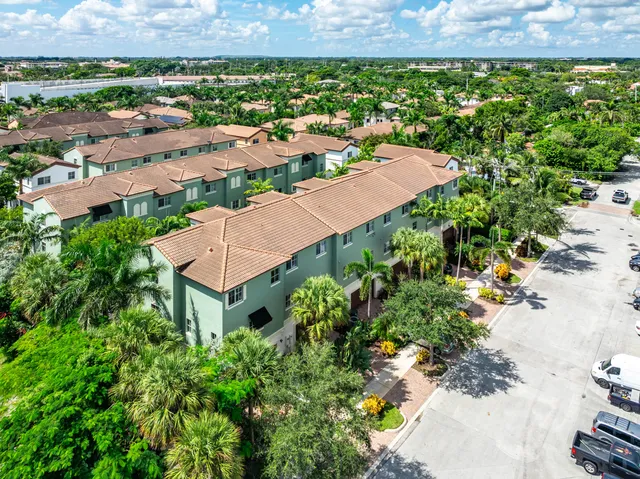 an aerial view of residential houses and lake