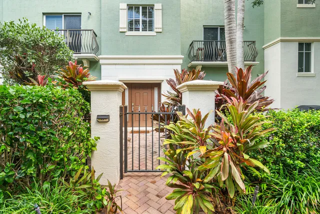 a view of a house with a small yard and plants