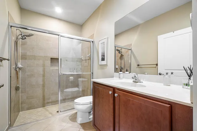 a bathroom with a sink mirror toilet and shower