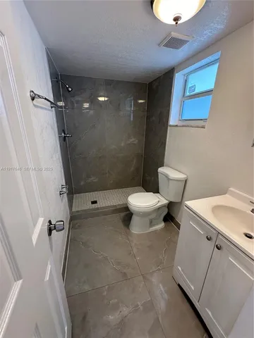 a view of a room with wooden floor and a window
