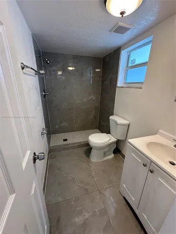 a view of a room with wooden floor and a window