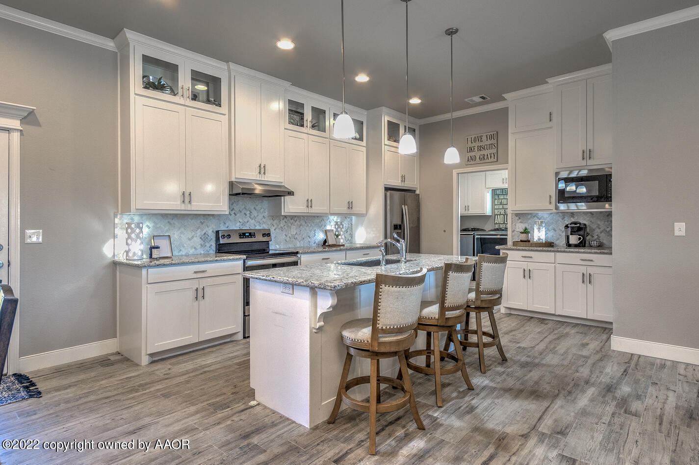 6103 Bowery Amarillo, TX 79119 - Photo 9 of 23 a kitchen with kitchen island granite countertop a sink cabinets and wooden floor
