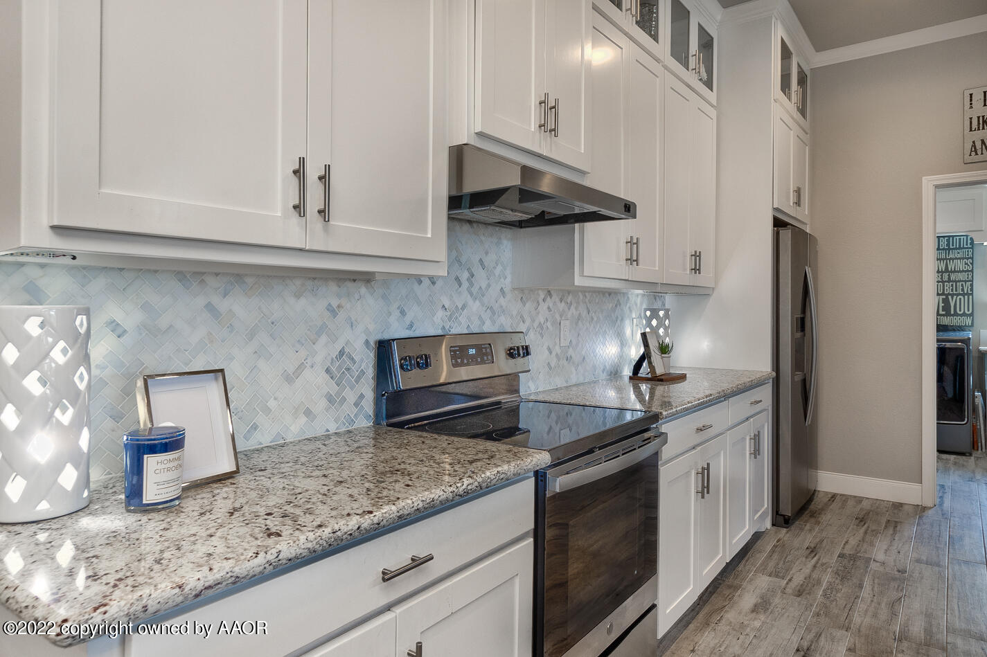 6103 Bowery Amarillo, TX 79119 - Photo 10 of 23 a kitchen with stainless steel appliances granite countertop white cabinets and a counter top space