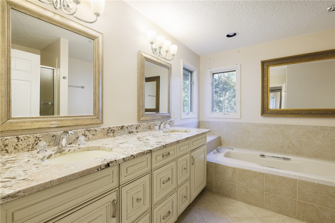 47 Gulf Stream Lane Salem, SC 29676 - Photo 13 of 48 This primary bathroom features a double vanity with granite counters and a luxurious soaking tub.