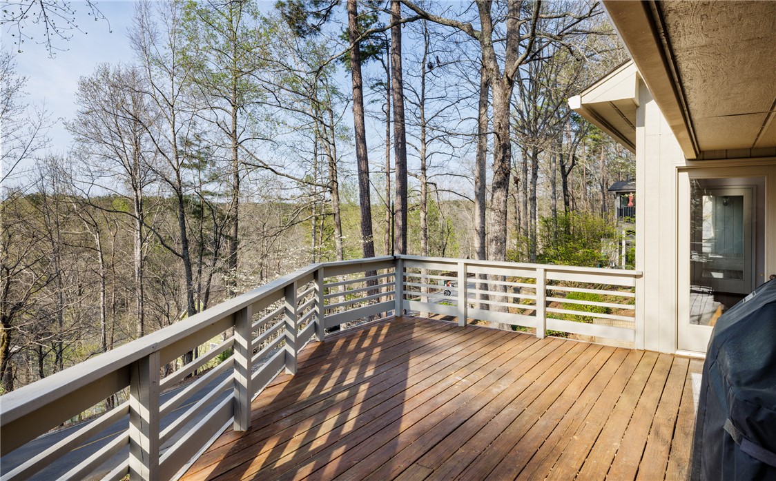 47 Gulf Stream Lane Salem, SC 29676 - Photo 27 of 48 This spacious wooden deck offers expansive views of the serene, wooded landscape.