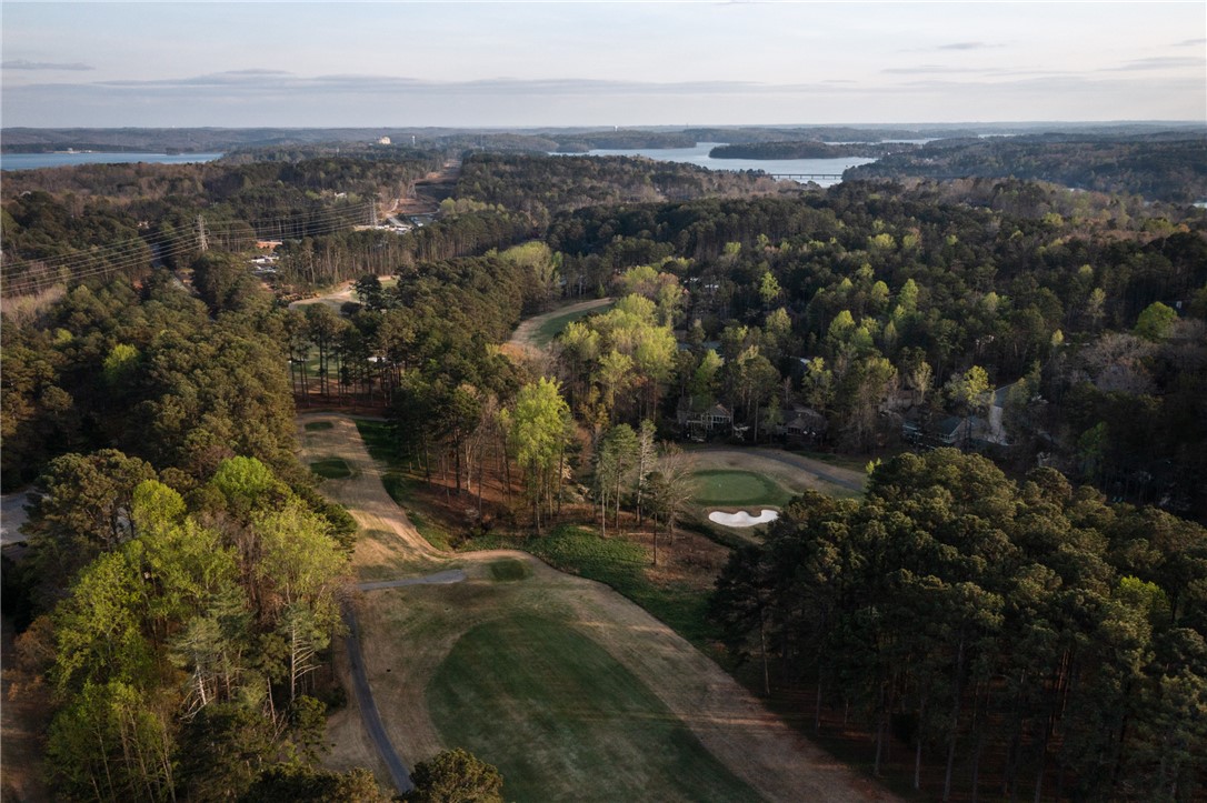 47 Gulf Stream Lane Salem, SC 29676 - Photo 29 of 48 This scenic aerial view captures a sprawling golf course nestled amongst lush trees, with a tranquil lake in the distance.
