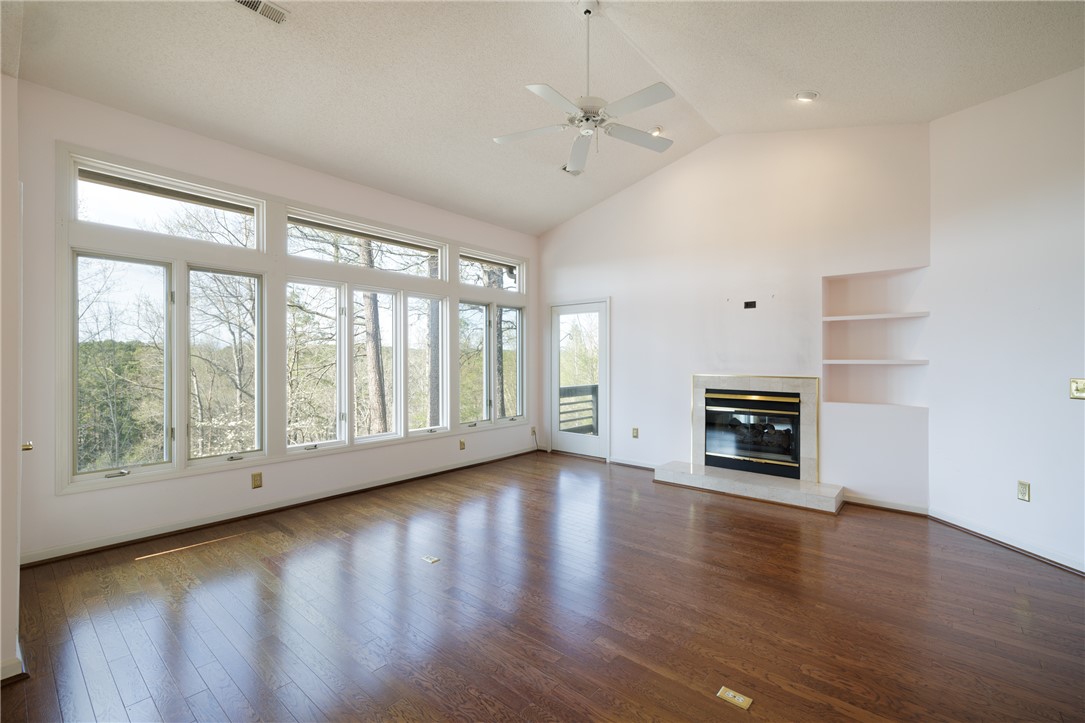 47 Gulf Stream Lane Salem, SC 29676 - Photo 3 of 48 This airy living space features expansive windows and a cozy fireplace, perfect for serene relaxation.
