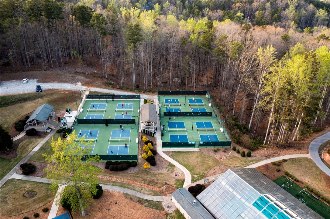 47 Gulf Stream Lane Salem, SC 29676 - Photo 36 of 48 Aerial view showcasing vibrant pickleball courts nestled within a wooded landscape.