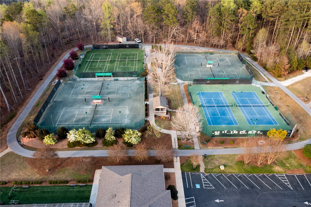 47 Gulf Stream Lane Salem, SC 29676 - Photo 37 of 48 This aerial view showcases multiple tennis courts nestled amongst lush greenery, offering recreational opportunities.