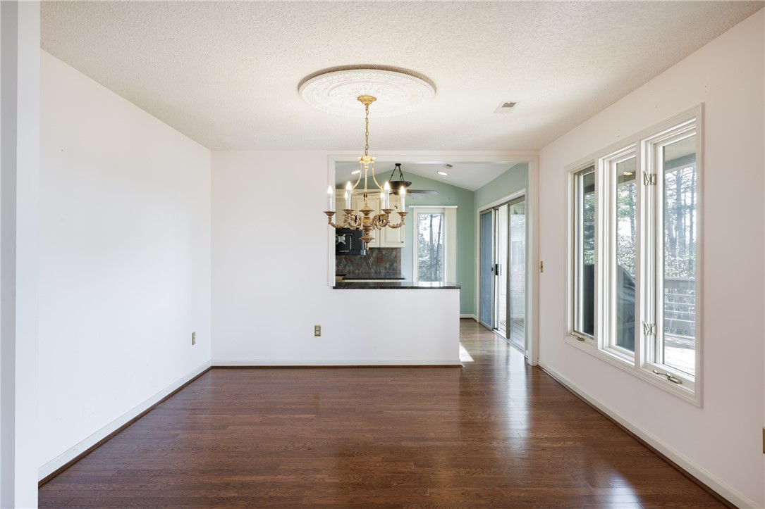 47 Gulf Stream Lane Salem, SC 29676 - Photo 4 of 48 This inviting space features lustrous wood flooring and a classic chandelier, offering a seamless transition to outdoor living.
