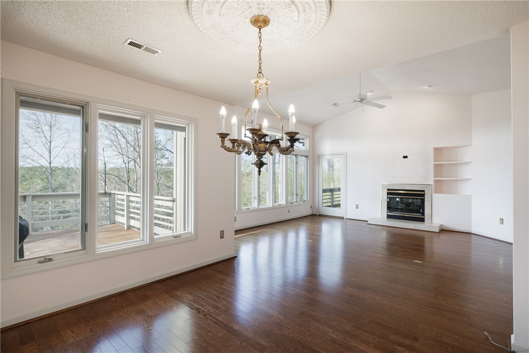 47 Gulf Stream Lane Salem, SC 29676 - Photo 42 of 48 This living area features a warm fireplace, rich hardwood floors, and abundant natural light.