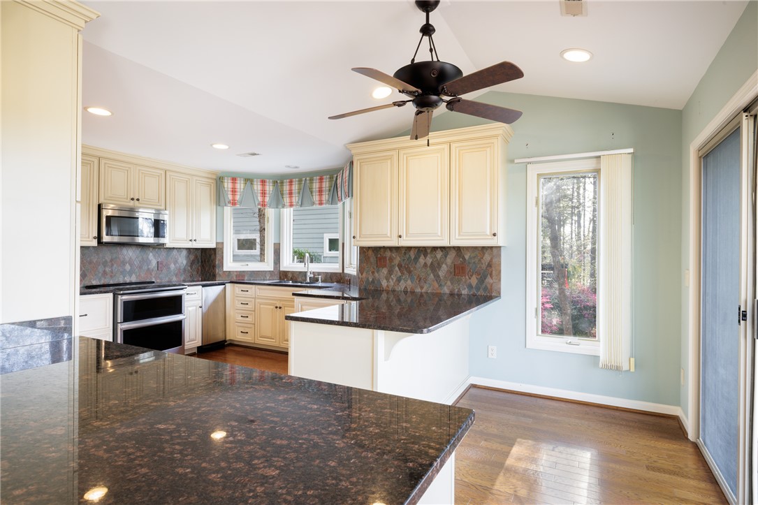 47 Gulf Stream Lane Salem, SC 29676 - Photo 5 of 48 This spacious kitchen offers ample counter space, abundant natural light, and elegant hardwood flooring.