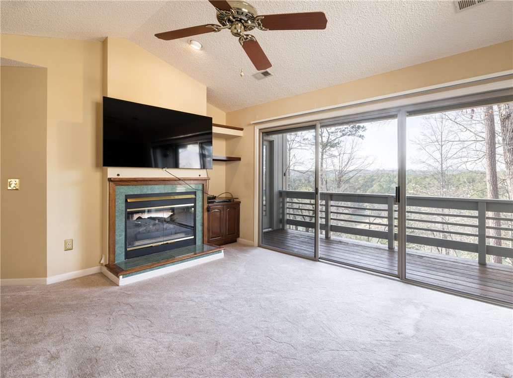 47 Gulf Stream Lane Salem, SC 29676 - Photo 10 of 48 This inviting space features a cozy fireplace and a private deck overlooking serene natural views.