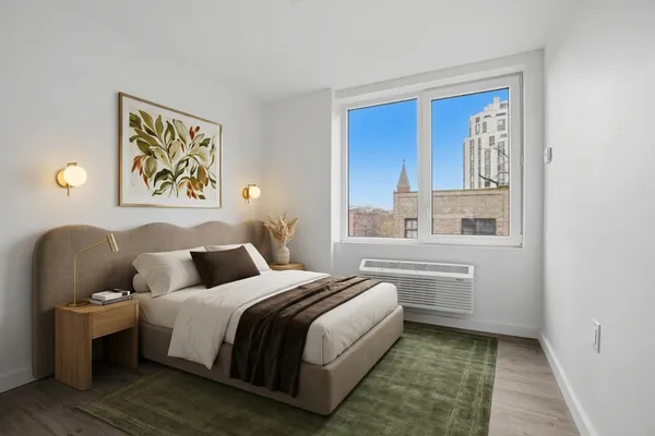 a bedroom with a bed and window