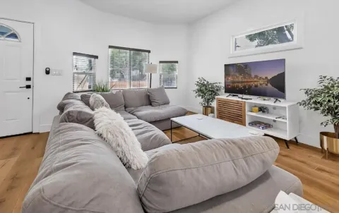 a living room with furniture and a flat screen tv