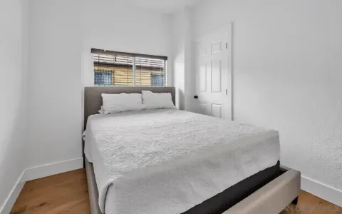a bedroom with a bed and a window