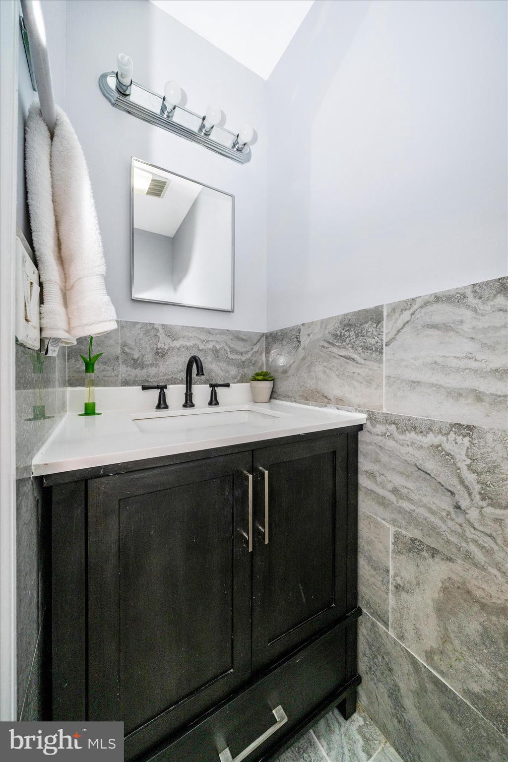 713 Seek Lane Silver Spring, MD 20912 - Photo 18 of 60 a bathroom with a sink vanity and a mirror