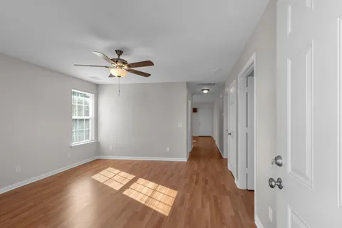 wooden floor in an empty room with a window