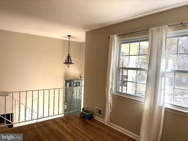 a view of a room with wooden floor and windows