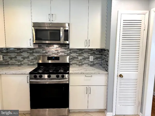 a kitchen with a stove and a microwave