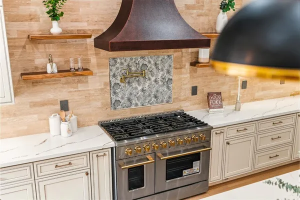 a bathroom with a tub a sink and a mirror