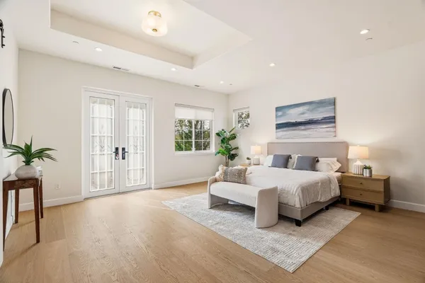 a bedroom with a bed and a potted plant