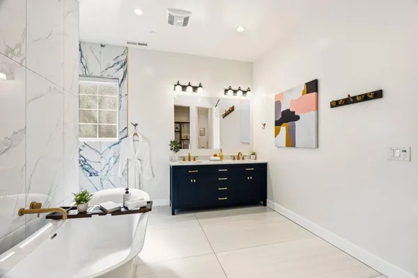 a bathroom with a sink mirror and shower