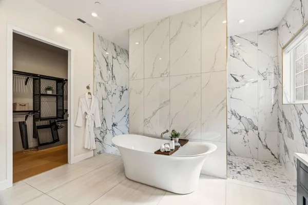 a kitchen with stainless steel appliances kitchen island granite countertop a refrigerator and cabinets