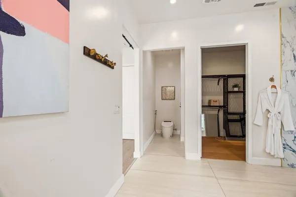 a kitchen with stainless steel appliances kitchen island granite countertop a refrigerator and a stove top oven