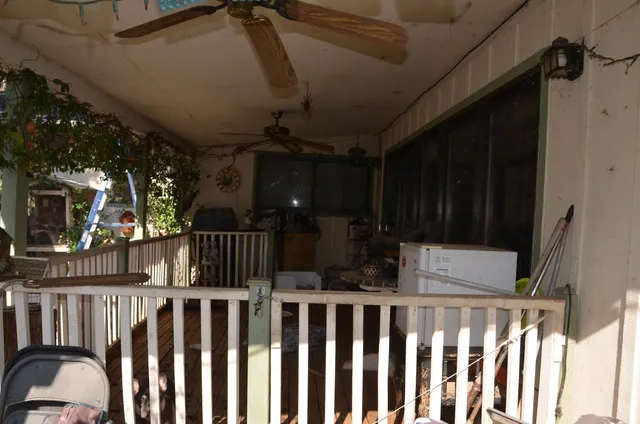 a view of staircase with railing and a chandelier