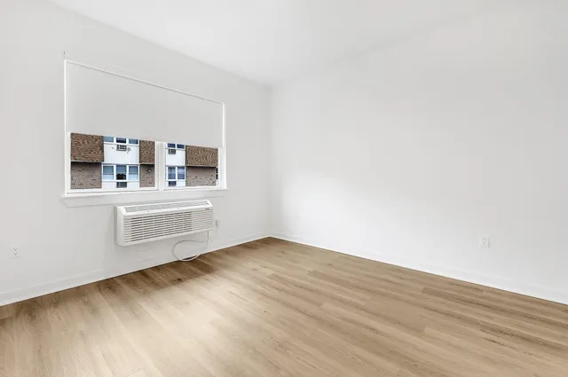 a view of a room with wooden floor