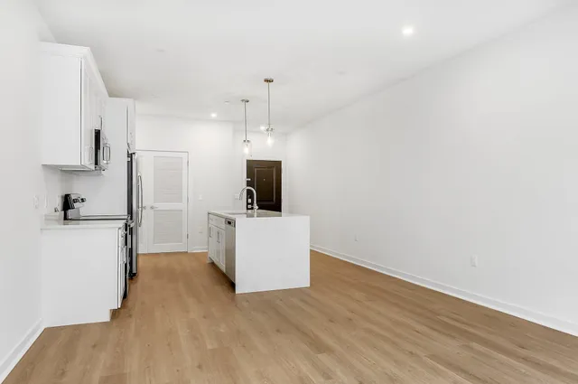a view of kitchen with microwave and refrigerator