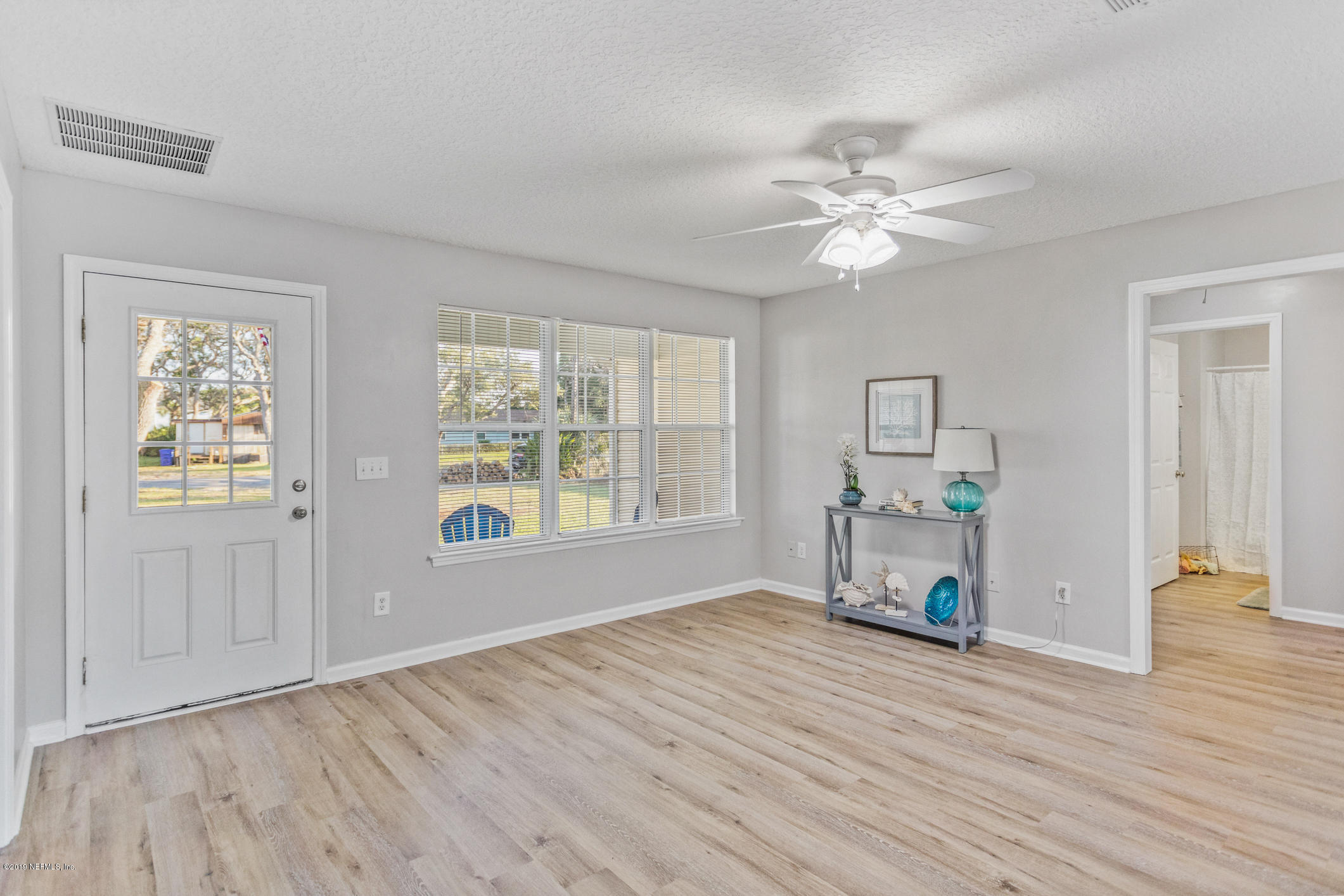 242 Puebla Road St. Augustine, FL 32080 - Photo 11 of 48 a view of empty room with wooden floor and fan