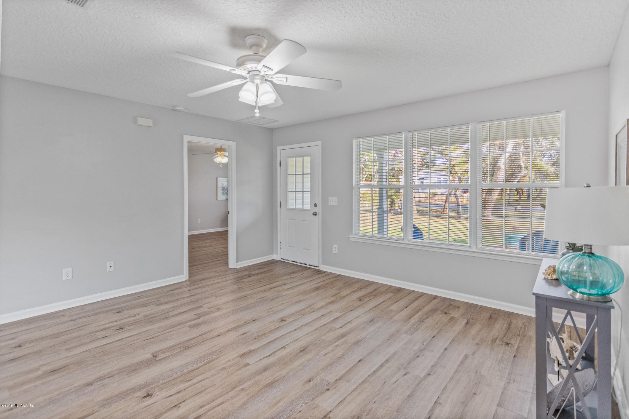 242 Puebla Road St. Augustine, FL 32080 - Photo 12 of 48 a view of an empty room with wooden floor and a window