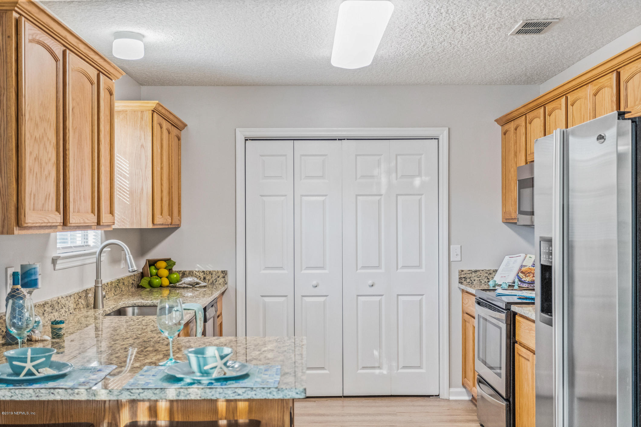 242 Puebla Road St. Augustine, FL 32080 - Photo 16 of 48 a kitchen with stainless steel appliances granite countertop a refrigerator and a stove top oven