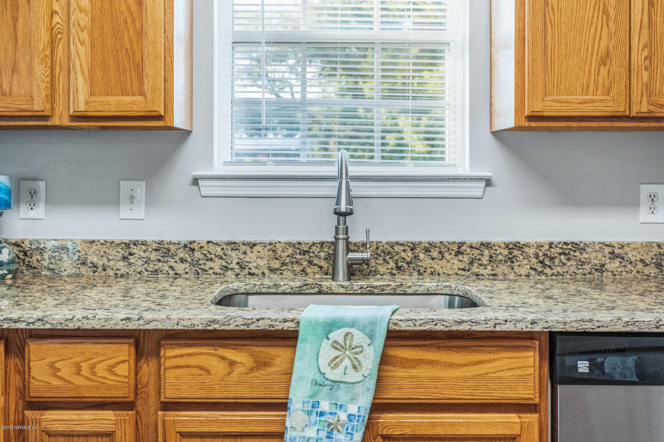 242 Puebla Road St. Augustine, FL 32080 - Photo 18 of 48 a kitchen with granite countertop a sink and a window