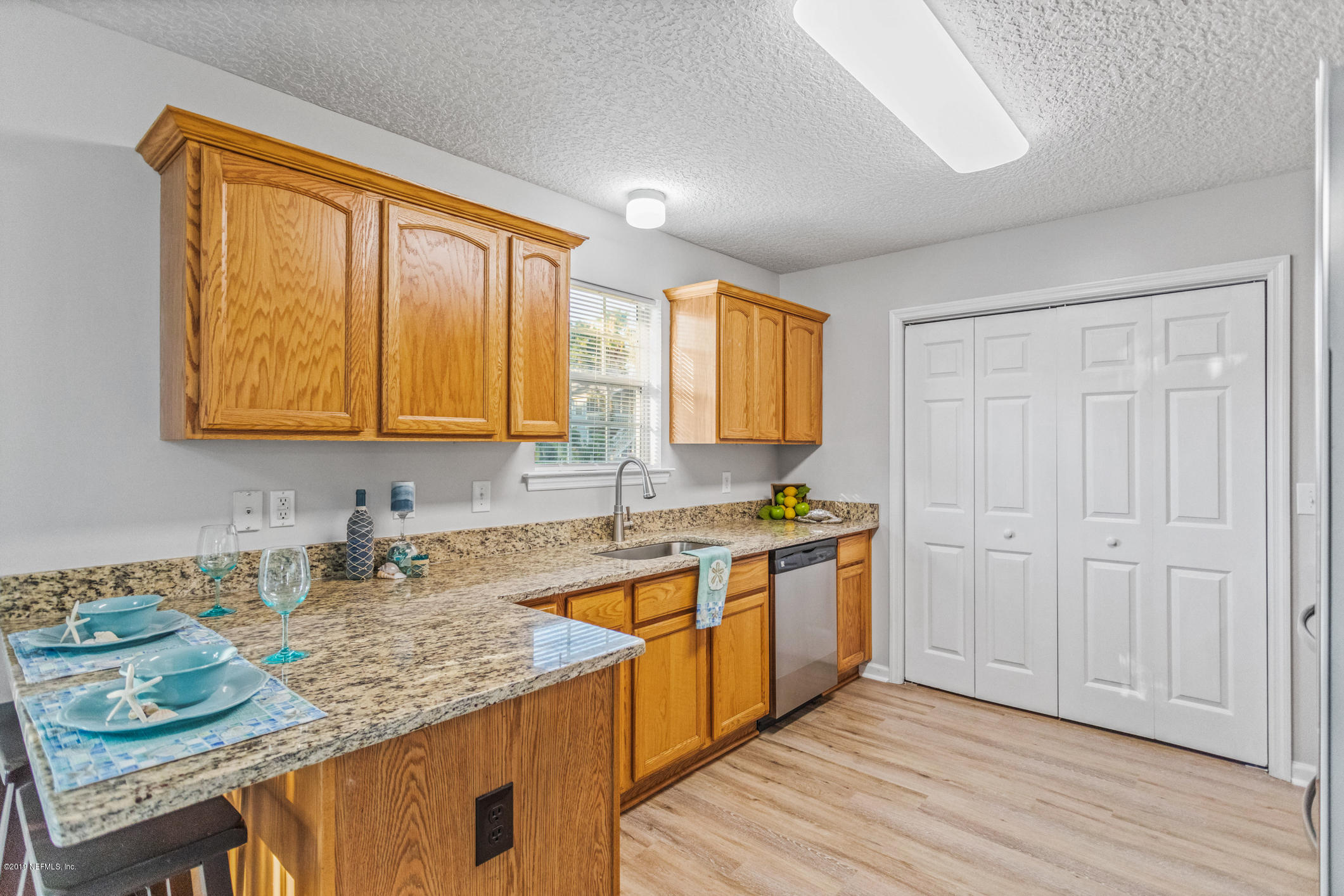242 Puebla Road St. Augustine, FL 32080 - Photo 20 of 48 a kitchen with stainless steel appliances granite countertop wooden cabinets a sink and dishwasher