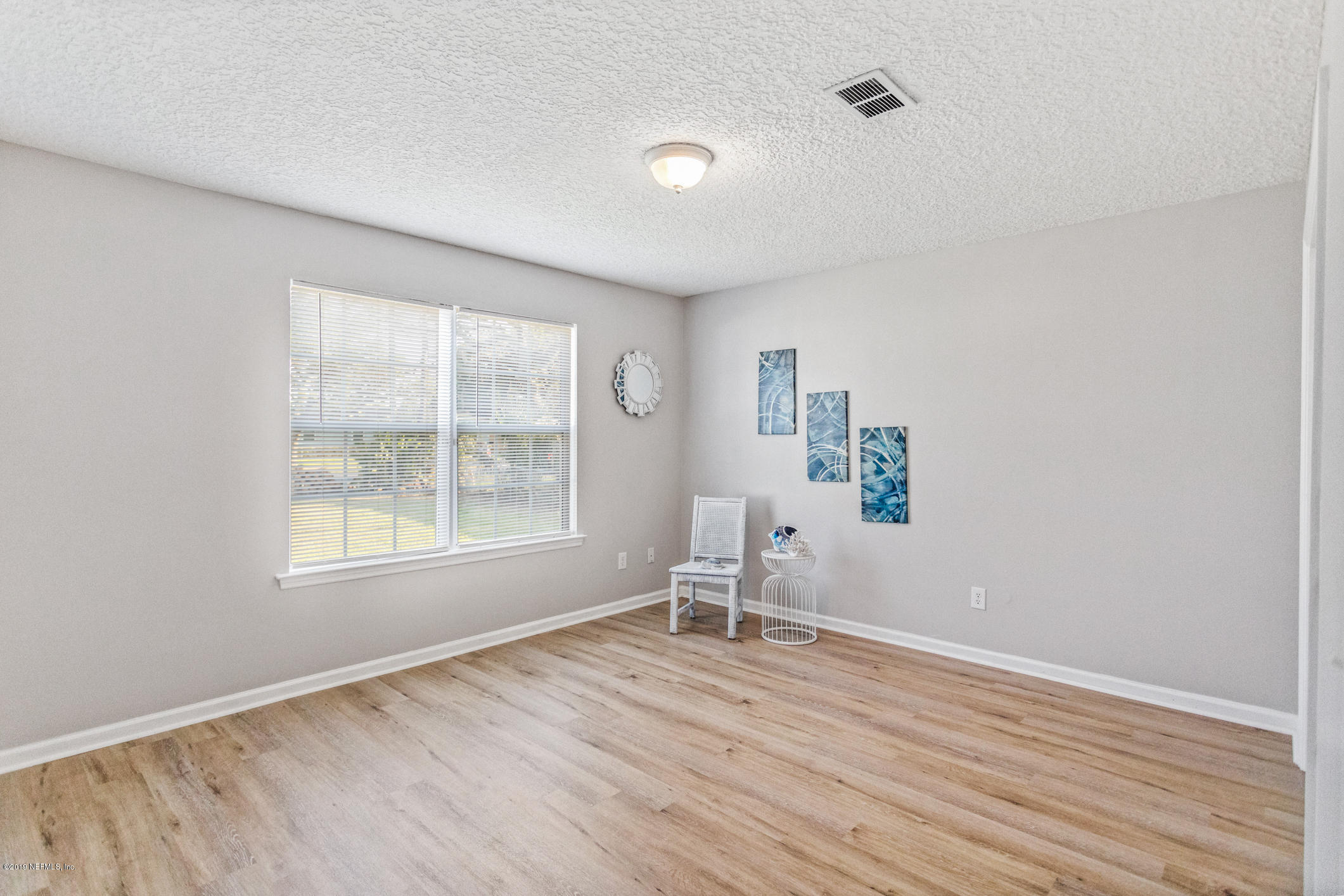 242 Puebla Road St. Augustine, FL 32080 - Photo 26 of 48 an empty room with wooden floor and windows