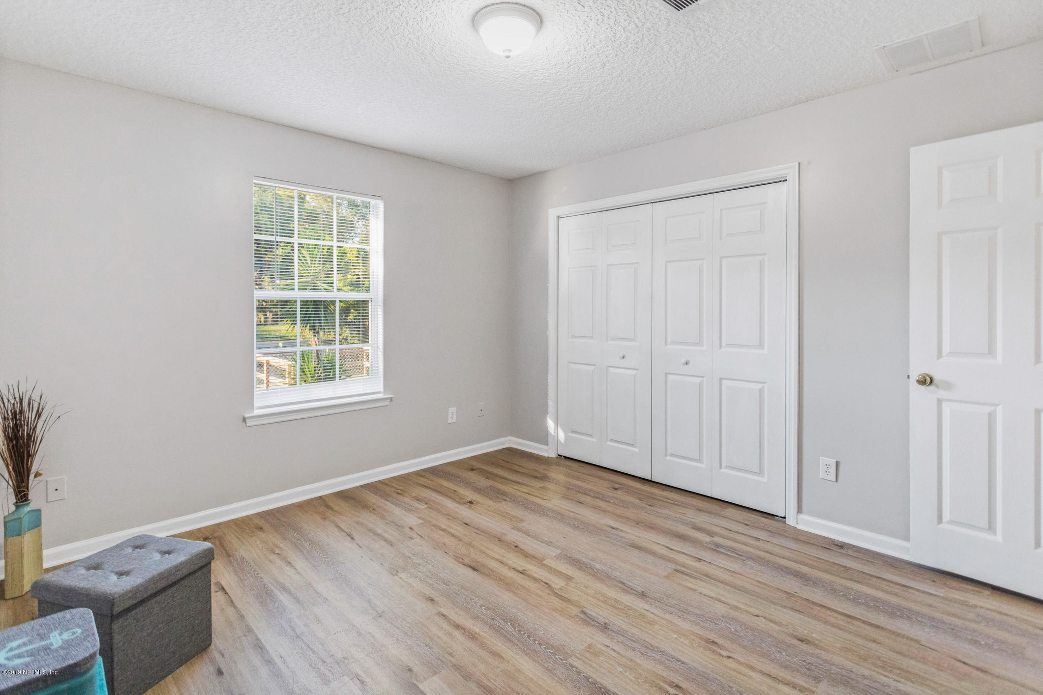 242 Puebla Road St. Augustine, FL 32080 - Photo 29 of 48 an empty room with wooden floor and windows