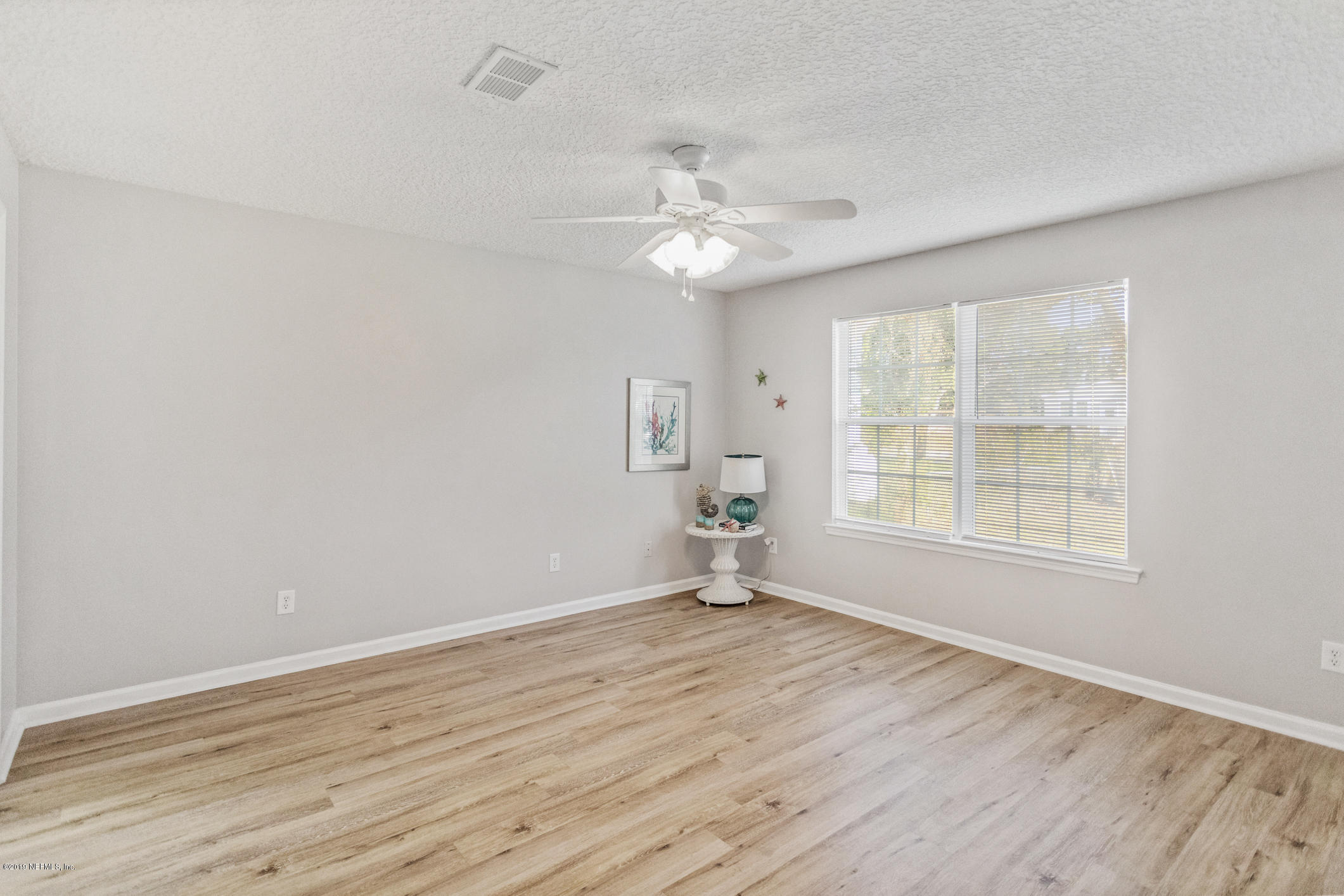 242 Puebla Road St. Augustine, FL 32080 - Photo 30 of 48 wooden floor in an empty room with a window