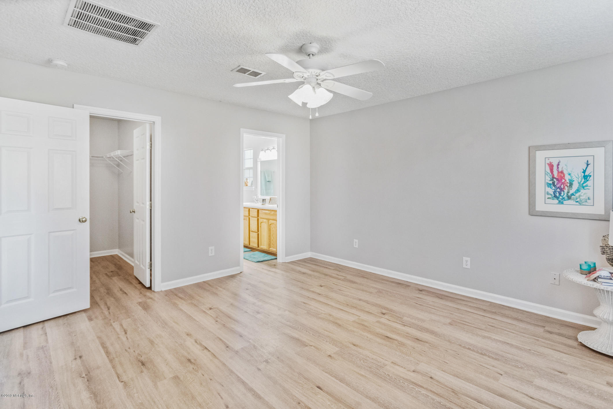 242 Puebla Road St. Augustine, FL 32080 - Photo 31 of 48 wooden floor in an empty room with a window
