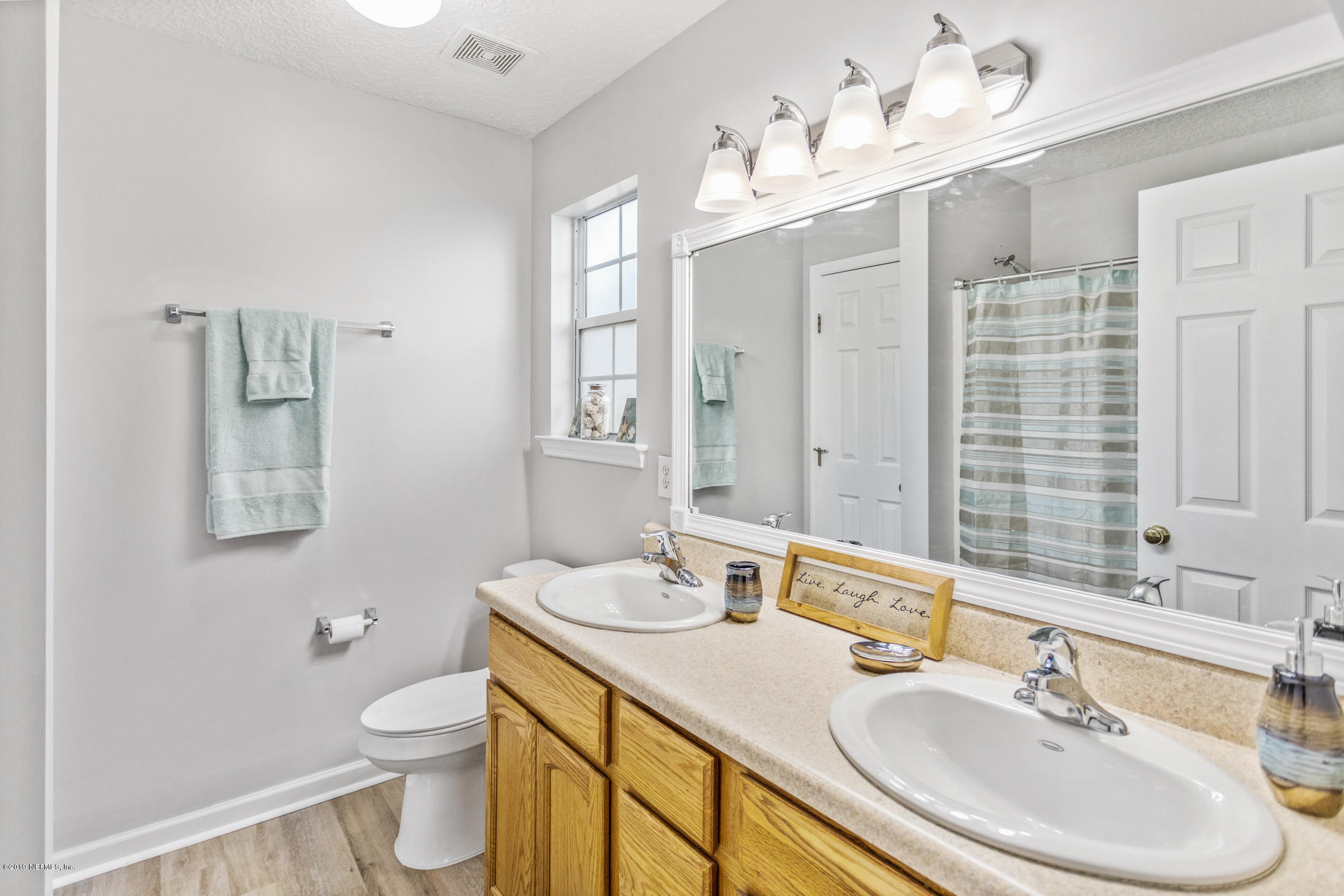 242 Puebla Road St. Augustine, FL 32080 - Photo 33 of 48 a bathroom with a double vanity sink mirror and toilet