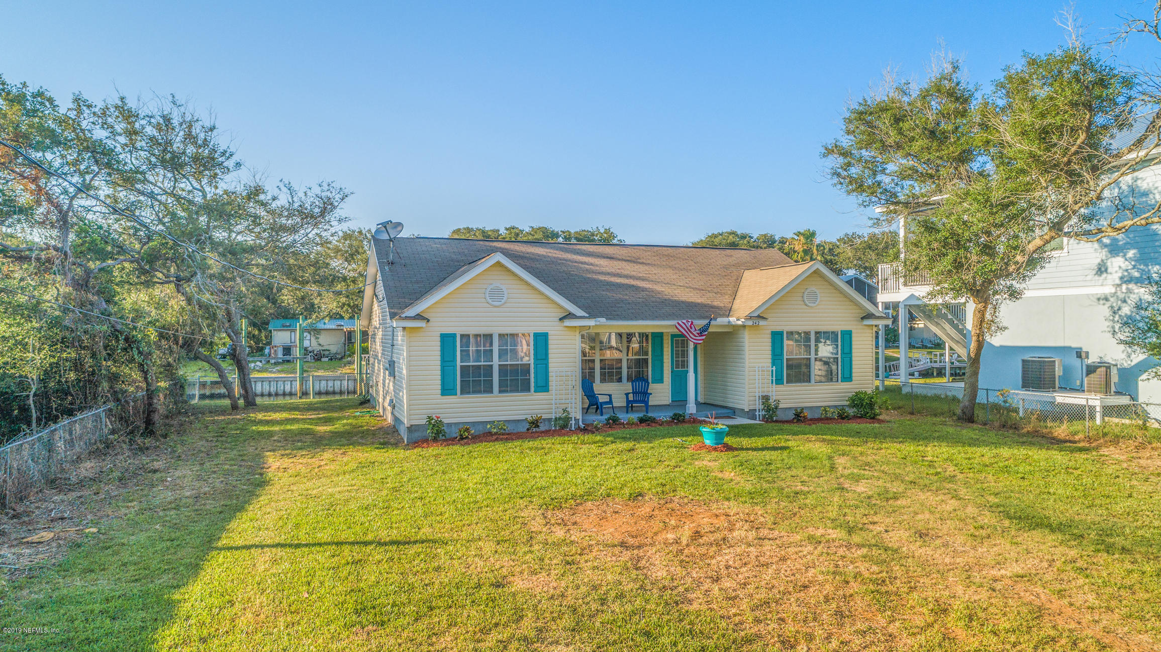 242 Puebla Road St. Augustine, FL 32080 - Photo 45 of 48 a front view of a house with a yard
