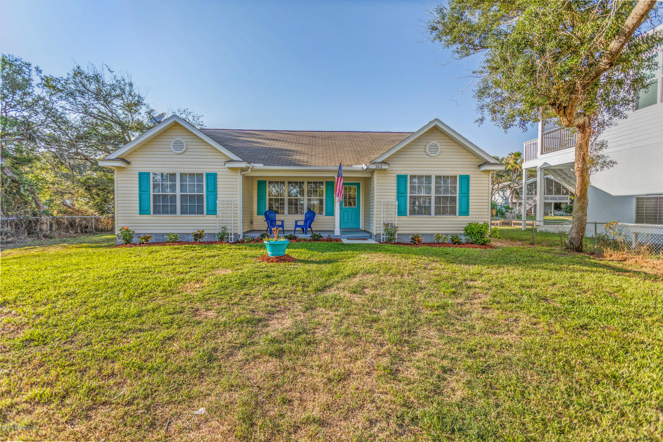 242 Puebla Road St. Augustine, FL 32080 - Photo 7 of 48 a front view of a house with a yard and trees