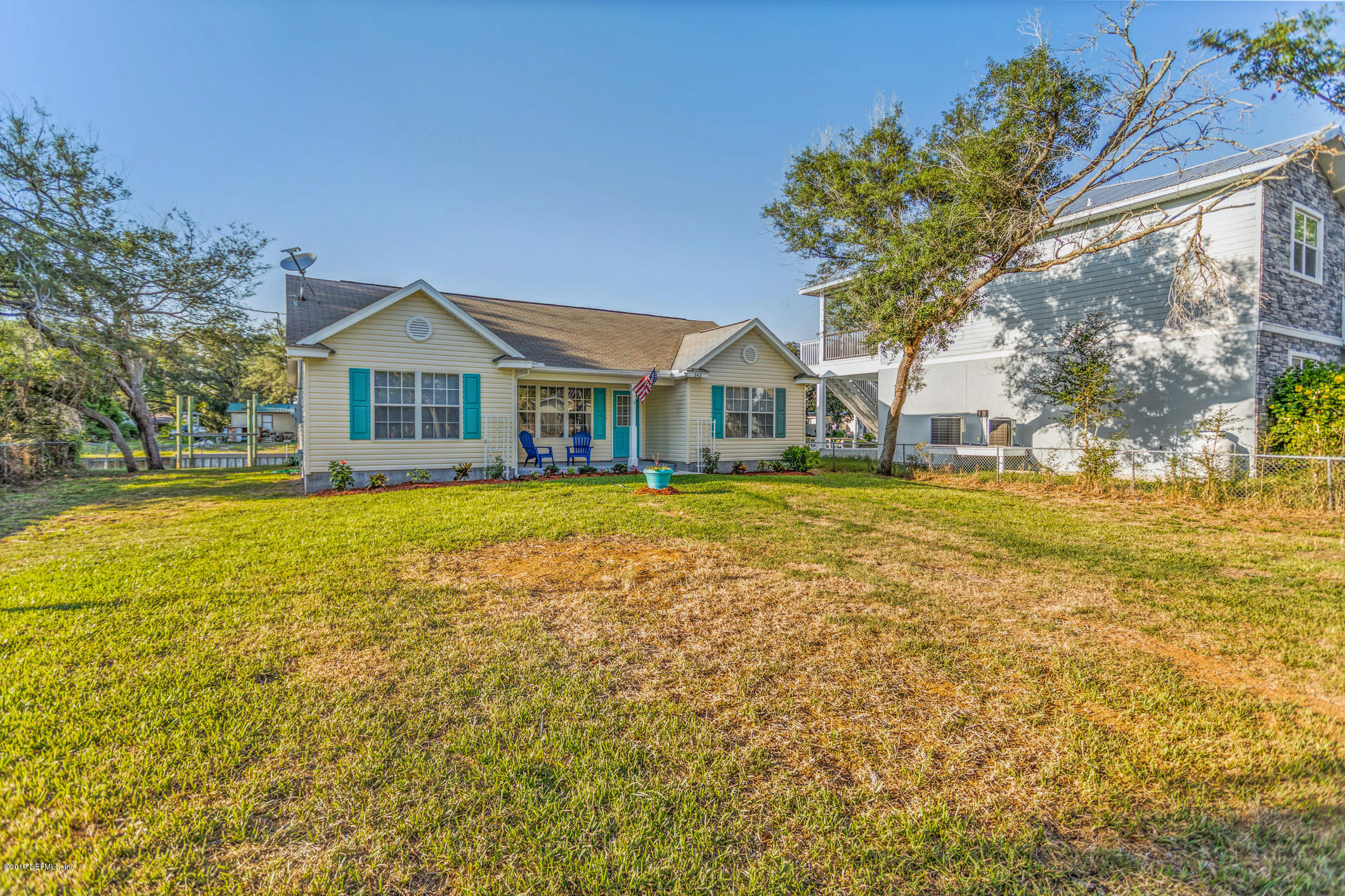 242 Puebla Road St. Augustine, FL 32080 - Photo 8 of 48 a front view of a house with a big yard