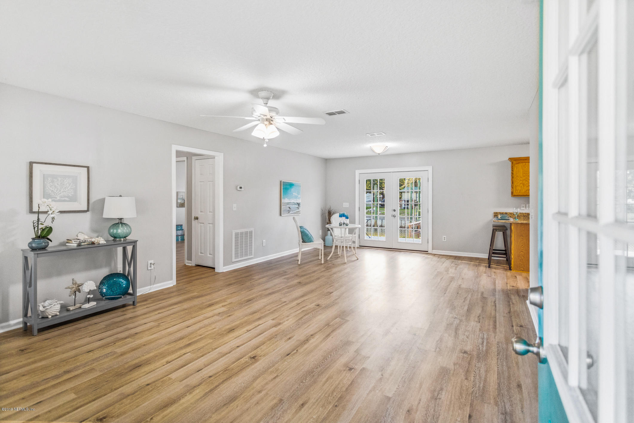 242 Puebla Road St. Augustine, FL 32080 - Photo 10 of 48 a view of an empty room with a window and wooden floor