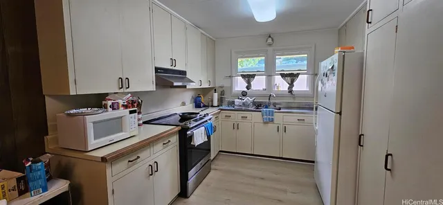 a kitchen with a refrigerator stove and sink